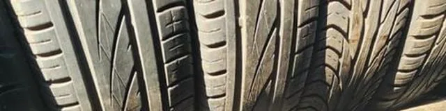Lee Tire rack of used tires with visible tread